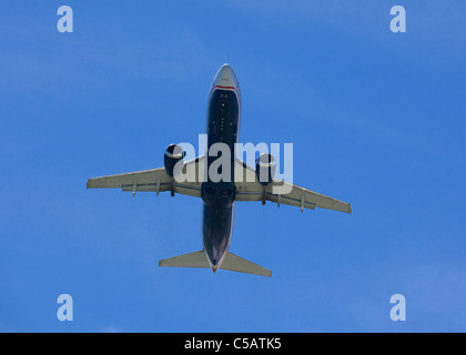 Bottom view of commuter jet against blue sky Stock Photo