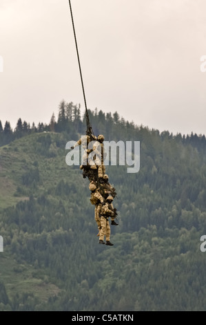 a fireteam of austrian special forces performs a spy rig extraction with a helicopter Stock Photo