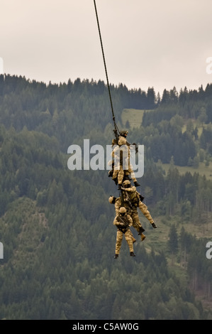 a fireteam of austrian special forces performs a spy rig extraction with a helicopter Stock Photo