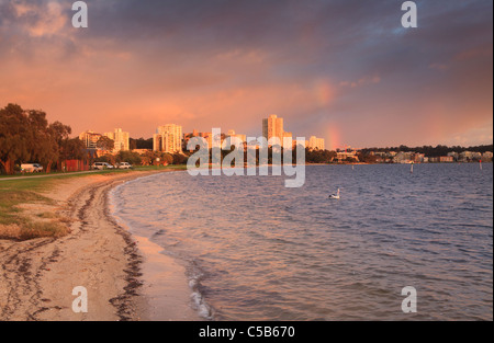 A rainbow at sunrise over South Perth and the Swan River