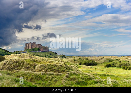 View over the dunes to Bamburgh Castle on the Northumberland coast, North East England, UK Stock Photo