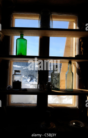 Historic artifact at bottle in window Shackleton's Hut Cape Royds Antarctica Stock Photo