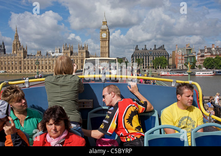 Tourists from Eastern Europe on an open-topped bus tour of London, UK.