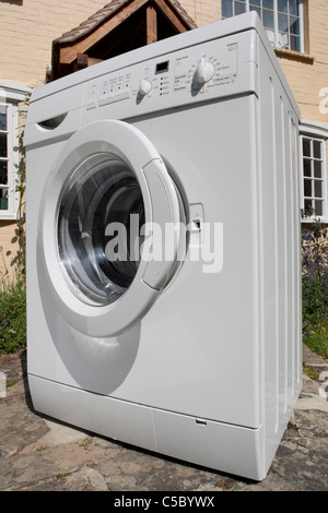 Clothes washing machine delivered outside house. Stock Photo