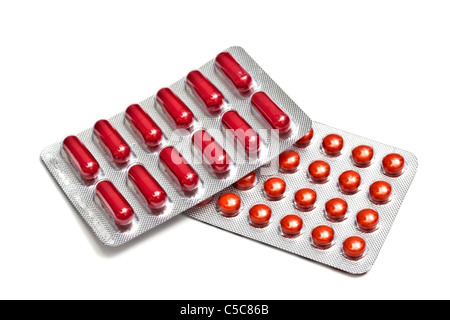 Red pills and capsules isolated on white background Stock Photo