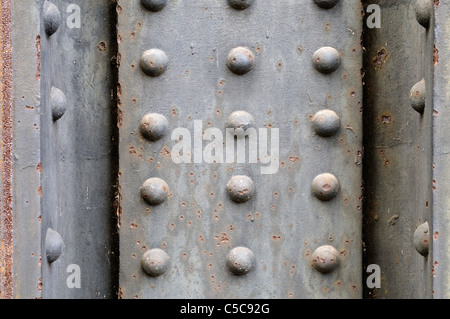 Grungy metal plate background with rivets. Stock Photo
