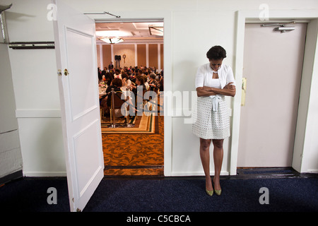 First Lady Michelle Obama waits to be introduced during an event at the Claremont Hotel Club Stock Photo
