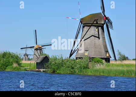 Thatched polder windmills along canal at Kinderdijk, a UNESCO World Heritage Site at South Holland, the Netherlands Stock Photo