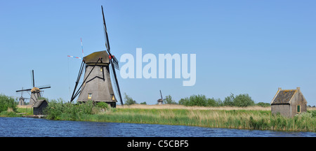 Thatched polder windmills along canal at Kinderdijk, a UNESCO World Heritage Site at South Holland, the Netherlands Stock Photo