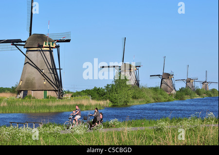 Row of thatched polder windmills along canal at Kinderdijk, a UNESCO World Heritage Site at South Holland, the Netherlands Stock Photo