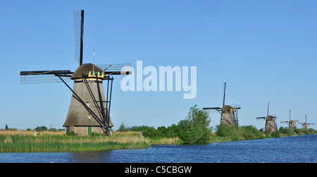 Row of thatched polder windmills along canal at Kinderdijk, a UNESCO World Heritage Site at South Holland, the Netherlands Stock Photo