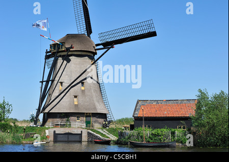 Thatched polder windmill along canal at Kinderdijk, a UNESCO World Heritage Site at South Holland, the Netherlands Stock Photo