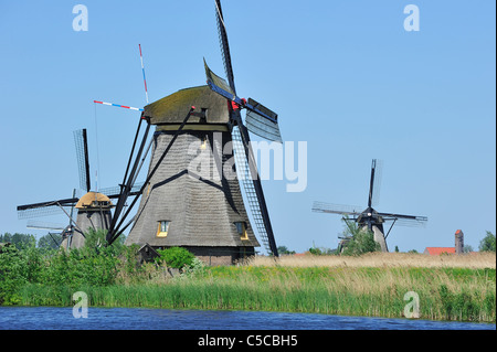 Thatched polder windmills along canal at Kinderdijk, a UNESCO World Heritage Site at South Holland, the Netherlands Stock Photo