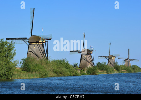 Row of thatched polder windmills along canal at Kinderdijk, a UNESCO World Heritage Site at South Holland, the Netherlands Stock Photo