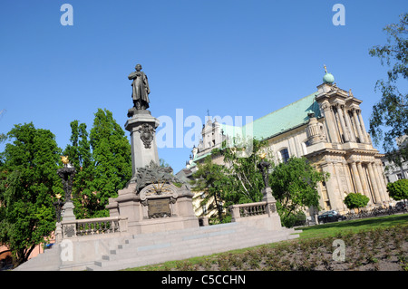 Adam Mickiewicz memorial in Warsaw Poland and St Joseph Care church, Krakowskie Przedmiescie Street Stock Photo