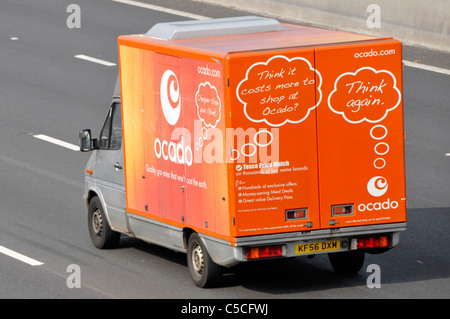 Side back rear & roof aerial view from above looking down on red Ocado online grocery food shopping delivery van & logo driving on English UK motorway Stock Photo