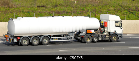 White unmarked articulated fuel tanker lorry and trailer with Hazchem Hazardous Chemicals and Dangerous Goods warning sign Stock Photo