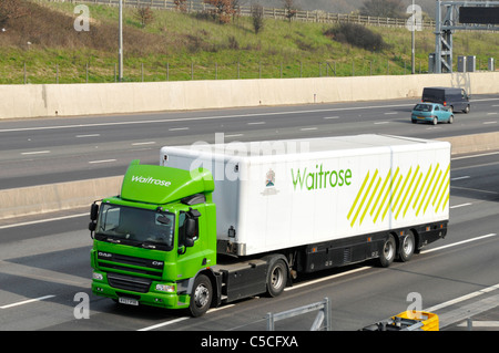 Side & front view Waitrose supermarket business green food supply chain store delivery lorry truck & driver trailer logo & Royal Warrant England UK Stock Photo