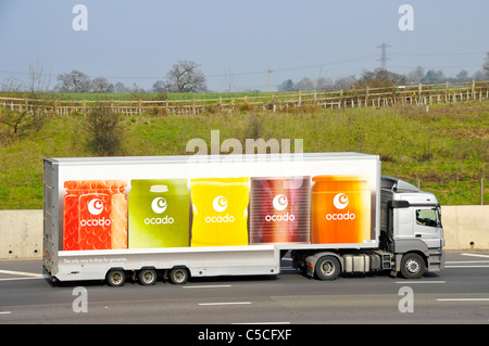 Ocado online internet shopping food grocery supply chain business side view hgv delivery lorry truck & articulated trailer logo on UK motorway Stock Photo