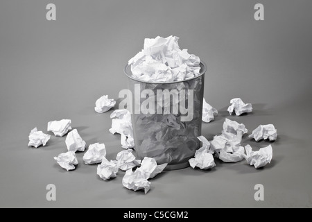 A trashcan filled with crumpled white papers Stock Photo