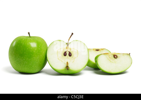 Whole fresh green apple and sliced pieces on white background Stock Photo