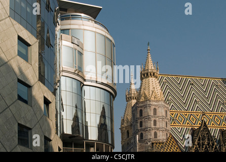 Contrast of Postmodernist Haas-Haus Building and Gothic St. Stephen's Cathedral (Stephansdom) in Vienna (Wien), Austria Stock Photo