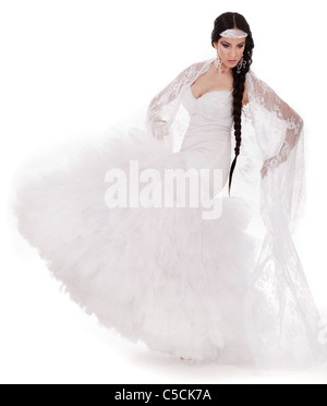 Young brunette dancing bride in white gown at white background Stock Photo