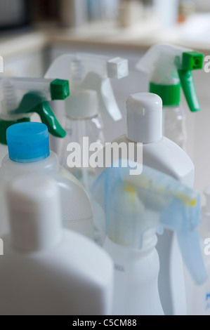 Collection of bottles containing different chemical cleaners in a domestic kitchen environment. Stock Photo