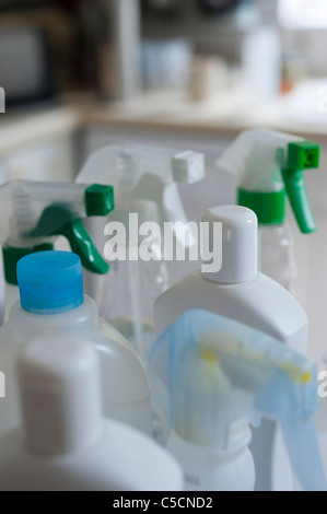 Collection of bottles containing different chemical cleaners in a domestic kitchen environment. Stock Photo