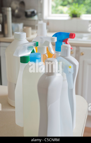 Collection of bottles containing different chemical cleaners in a domestic kitchen environment. Stock Photo