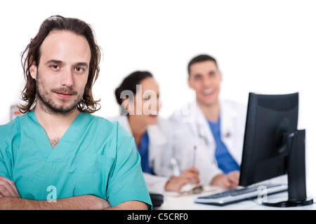 Male doctor on focus, two doctors discussing at background Stock Photo