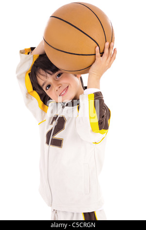 Little kid while throwing the basketball on white isolated background Stock Photo