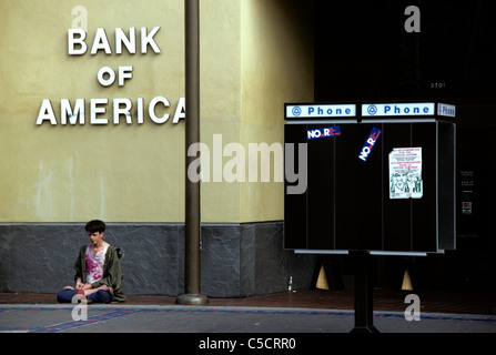 man sits begging in front of Bank of America in 1969 in San Francisco Stock Photo