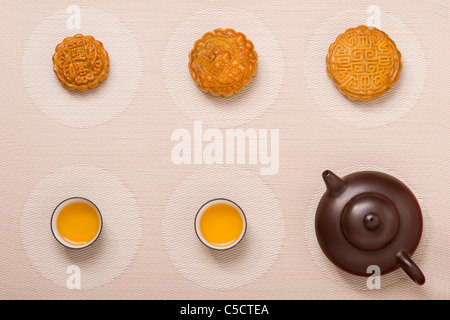 Moon Cakes with Tea on Geometric Place Mat Stock Photo
