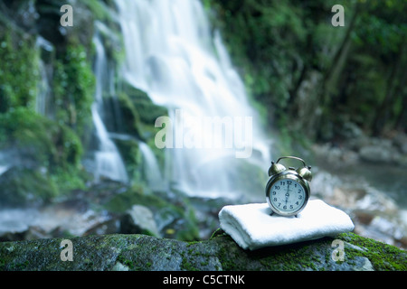 clock and towel on the rock Stock Photo