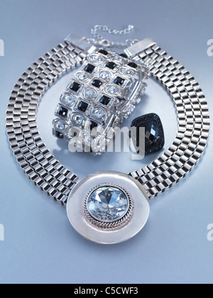 Pendant necklace, a bracelet and a ring jewellery isolated on gray background Stock Photo