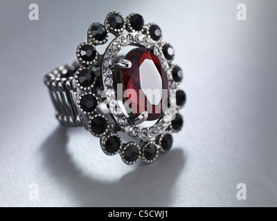 Closeup of a ring with red stone. Jewellery isolated on gray background. Stock Photo