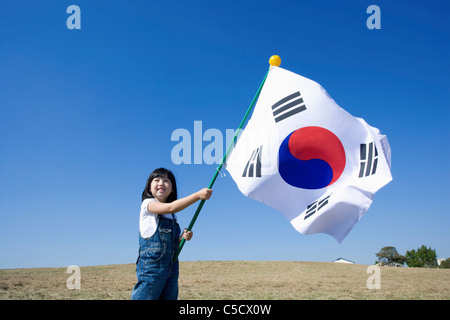 Korean National Flag blowing in girl's hand Stock Photo