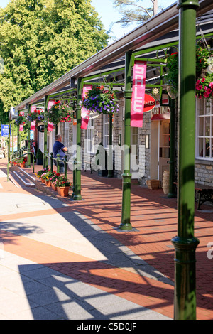 Flower baskets and covered walkways at the Clarks Shoe Village Somerset Stock Photo