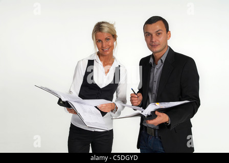 Portrait of a male and female business colleagues with documents against gray background