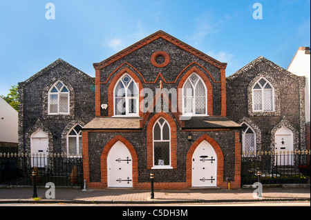 GREENHITHE, KENT, UK - JUNE 26, 2011:   A building built of rough and knapped flint the High Street Stock Photo