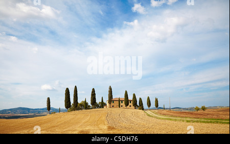 Classic Tuscan farm house and cyprus trees in Tuscany, Italy Stock Photo