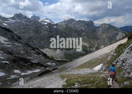 Hiker descending from Meded Peak into Lokvice valley (far center) Bobotov kuk Stock Photo