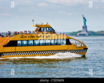 The New York Water Taxi Sam Holmes passes the Statue of Liberty in New York Harbor, and is based in Red Hook, Brooklyn. Stock Photo