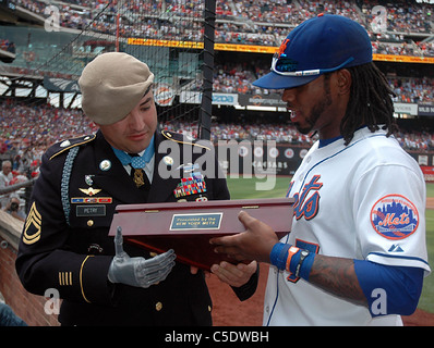 Medal of Honor recipient Sgt. 1st Class Leroy A. Petry, receives a plaque from the New York Mets shortstop Jose Reyes Stock Photo