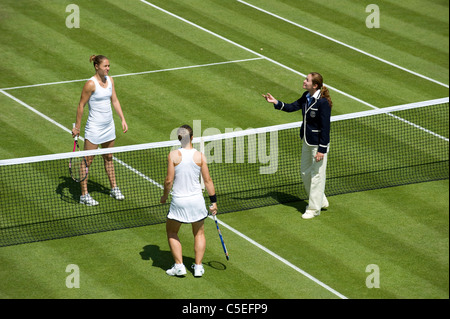 The coin toss by the umpire before a game on court 4 during the 2011 Wimbledon Tennis Championships Stock Photo