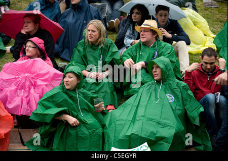 Crowds watch the big screen on Aorangi Terrace in the rain during the 2011 Wimbledon Tennis Championships Stock Photo