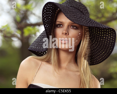 Portrait of a beautiful young woman wearing a sun hat Stock Photo