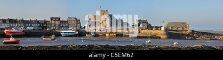 The Eglise Saint-Nicolas / Church of Saint-Nicolas and fishing boats at the port of Barfleur, Normandy, France Stock Photo