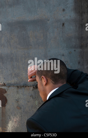 Worried black male head in hands looking away Stock Photo